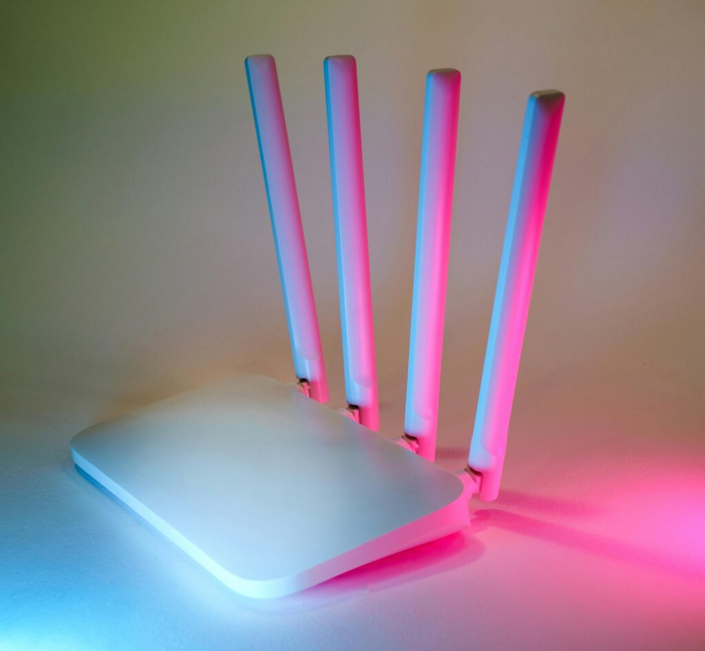 A sleek wireless router enhanced by vibrant neon lights, showcasing cutting-edge technology.